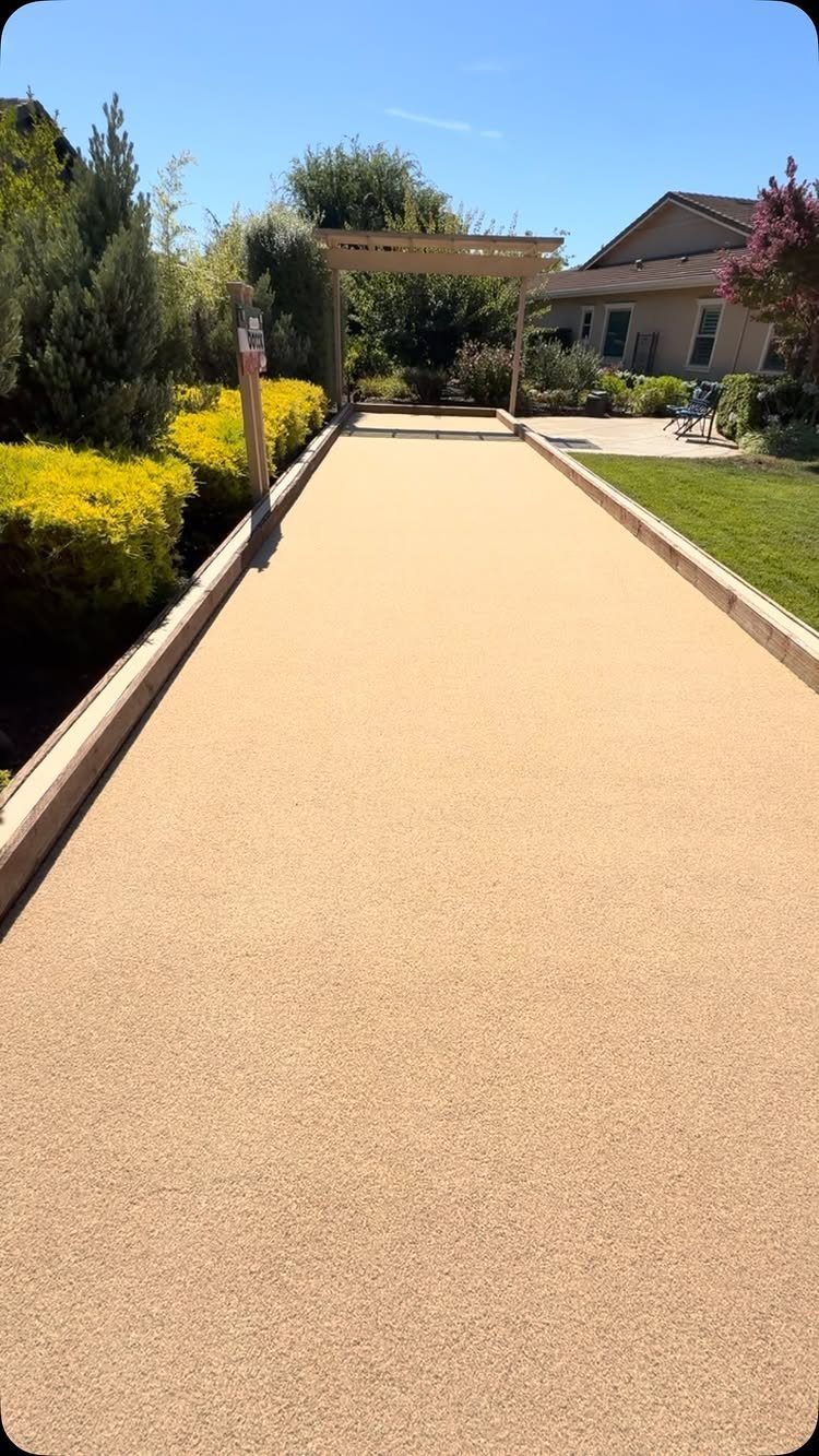 23 Backyard DIY Ideas for a Patio, Garden and Fire Pit 23 Bocce ball court with tan crushed stone surface and wooden borders in a backyard.