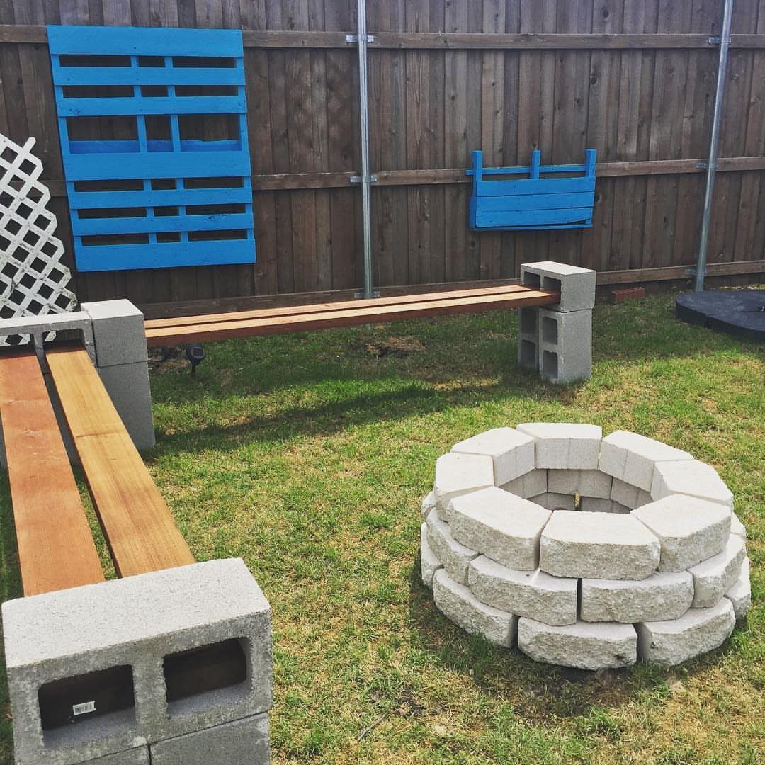 23 Backyard DIY Ideas for a Patio, Garden and Fire Pit 7 Circular concrete block fire pit on a lawn with DIY wooden benches.