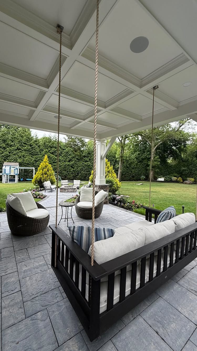 23 Backyard DIY Ideas for a Patio, Garden and Fire Pit 19 Black porch swing with white cushions under a white coffered patio ceiling