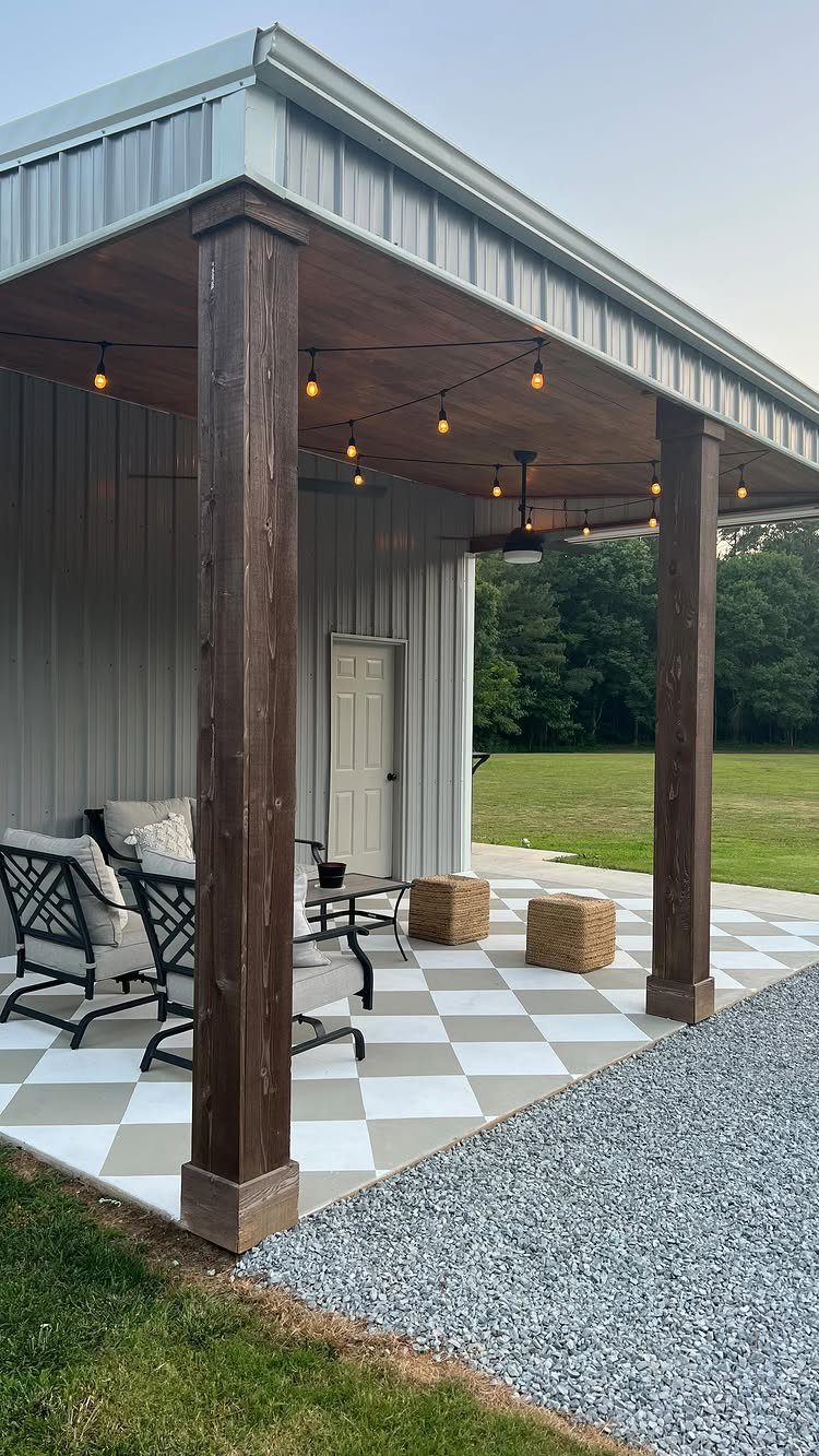 Checkered beige and white painted patio floor under a covered porch with string lights.