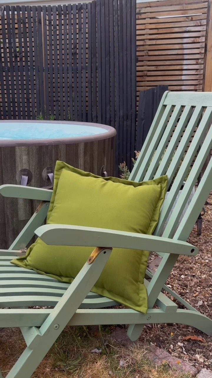14 Cheap Garden Makeover Ideas to Refresh Your Yard 11 Light green painted wooden lounge chair with a lime green cushion in a garden