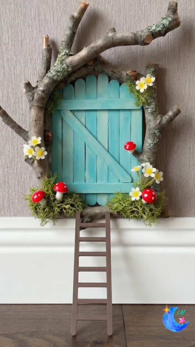 Small blue fairy door on a wall framed by branches, moss, and mushrooms.