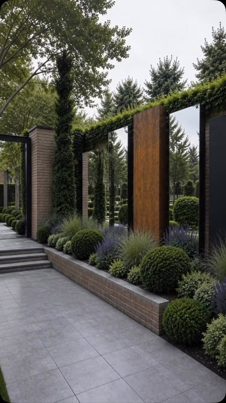 26 Front Garden Ideas for Curb Appeal and Small Yards 15 Modern garden wall with large mirrors, rusted metal, and manicured green shrubs.