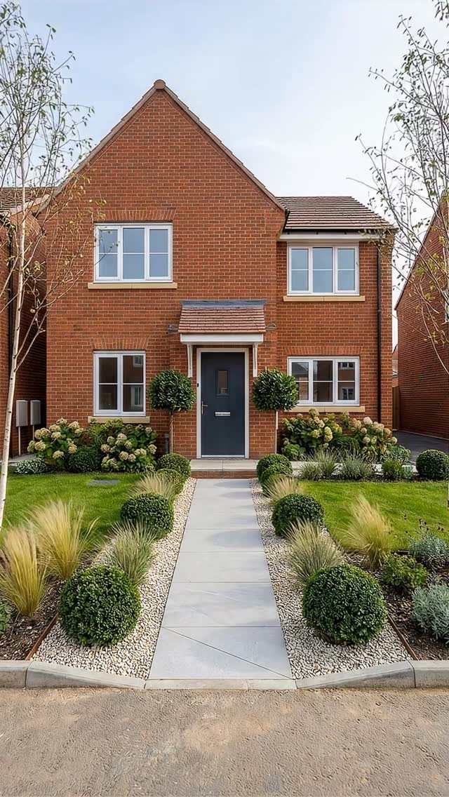 26 Front Garden Ideas for Curb Appeal and Small Yards 10 Symmetrical garden landscaping with round shrubs and grasses flanking a house entry path.