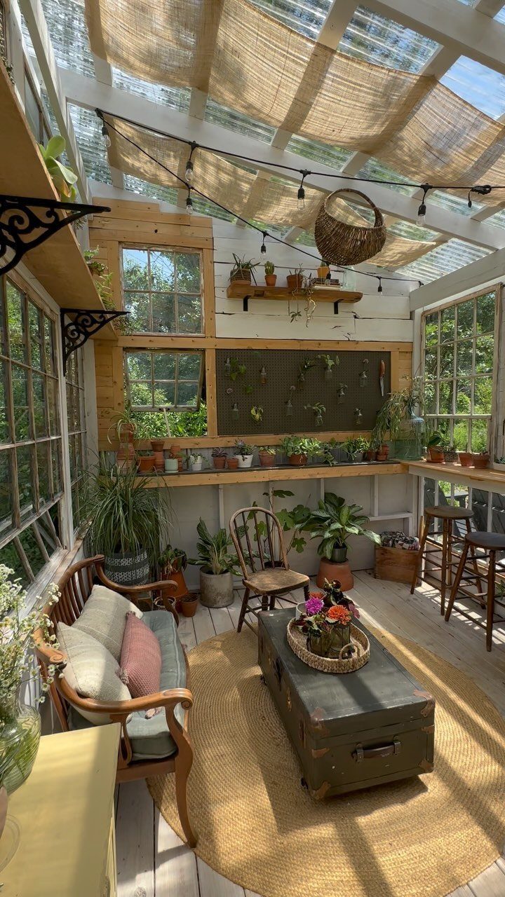 Green House Layout: 17 Ideas for Benches, Beds and Lighting 4 Sunroom interior with glass roof, potted plants, wooden furniture, and a woven rug.