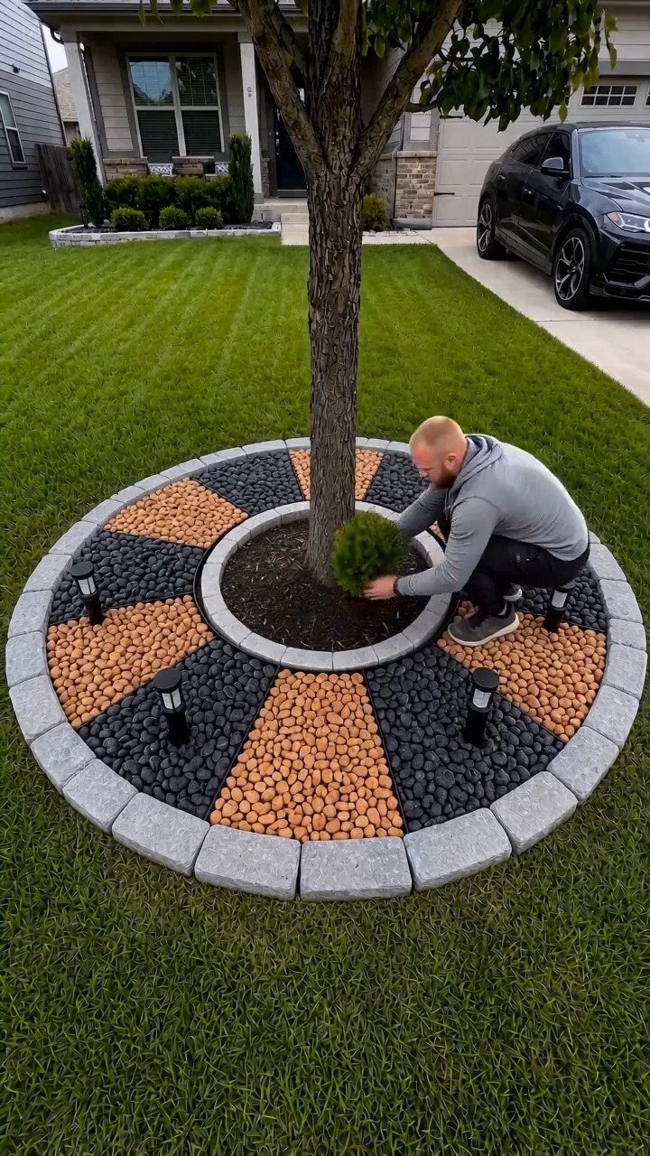 10 Ideas for Landscaping Around Trees, From Moss to Lighting 6 Circular brick tree edging with alternating black and tan pebble sections in a lawn