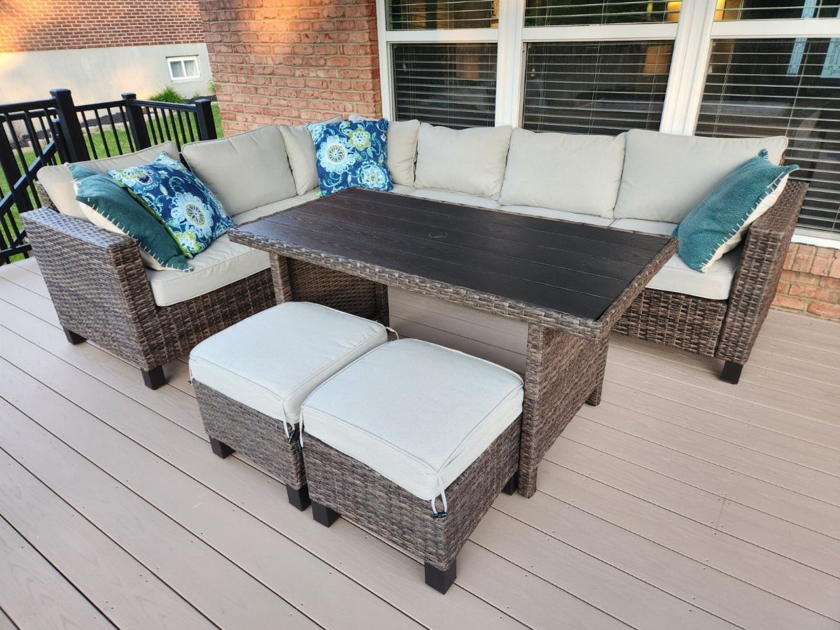 Outdoor Modular Seating: 20 Sectionals and Sofa Sets 12 Grey wicker sectional sofa with beige cushions, a dark table, and two ottomans.