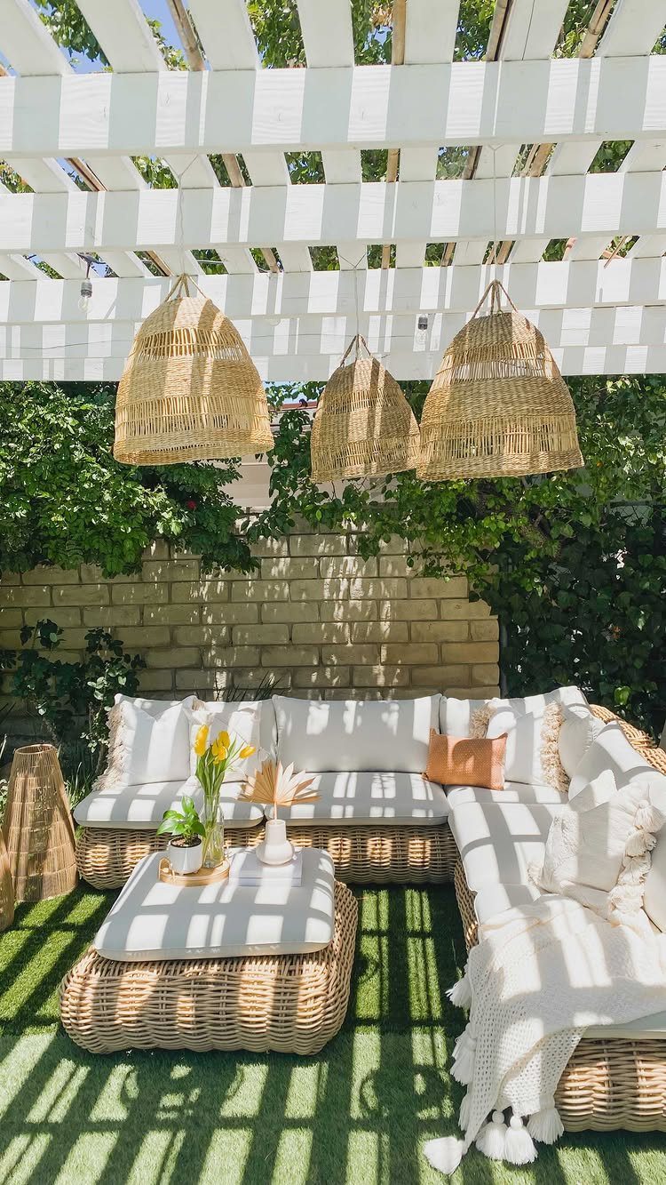 Outdoor Modular Seating: 20 Sectionals and Sofa Sets 4 Wicker outdoor sectional sofa with white cushions under a white pergola with woven lamps.