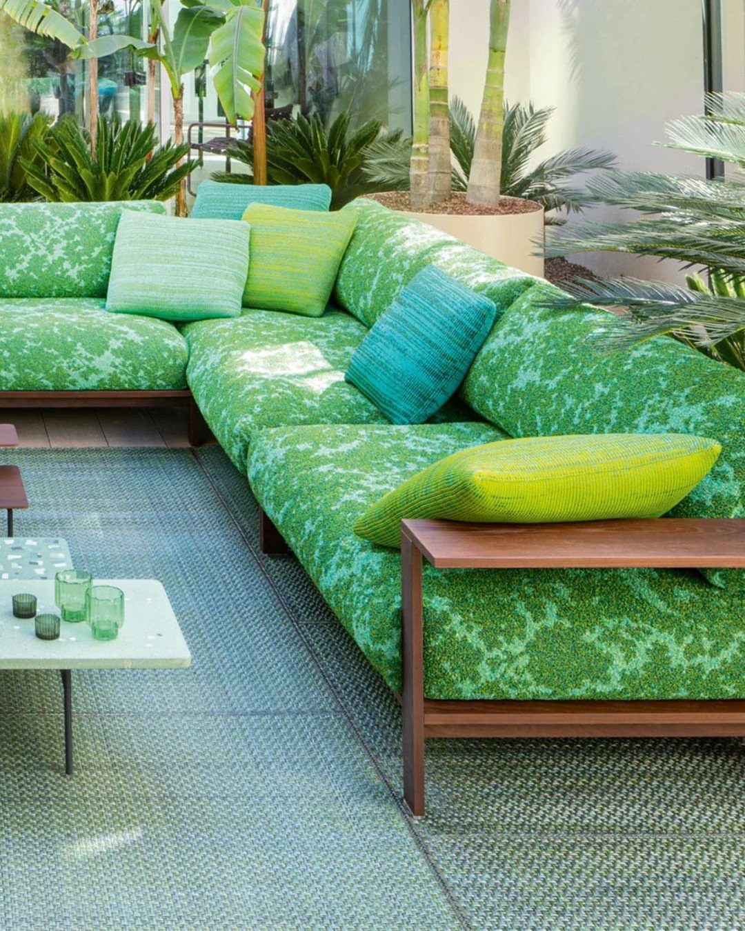 Outdoor Modular Seating: 20 Sectionals and Sofa Sets 11 Green patterned L-shaped outdoor sectional sofa with colorful pillows on a grey rug.