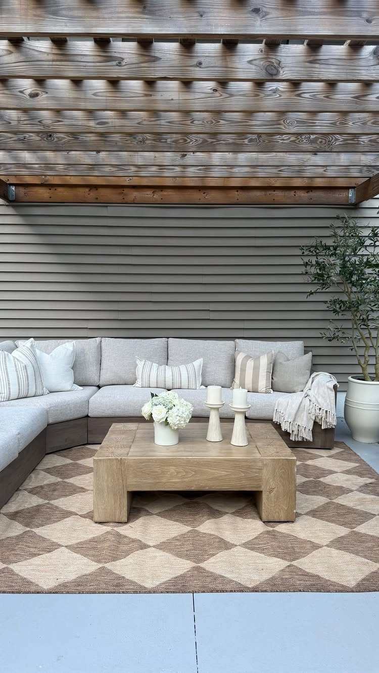 Outdoor Modular Seating: 20 Sectionals and Sofa Sets 14 Light grey L-shaped modular outdoor sectional sofa with wooden coffee table and checkered rug.
