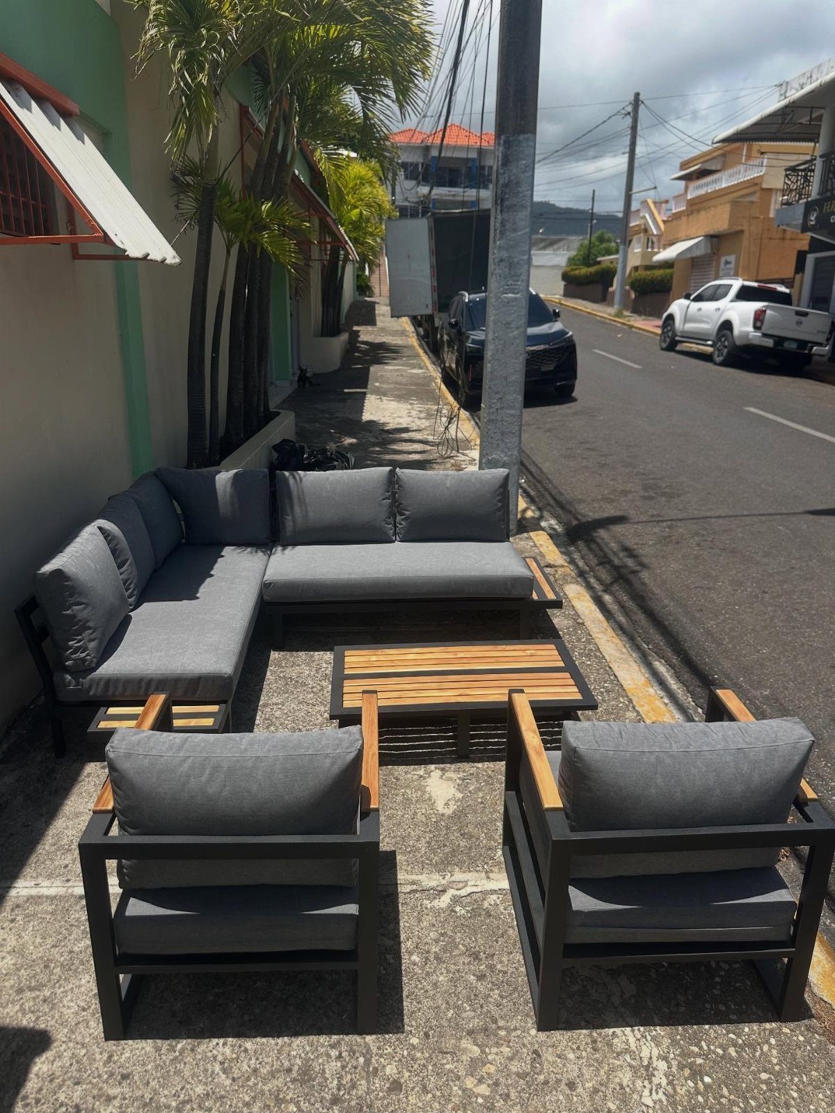 Outdoor Modular Seating: 20 Sectionals and Sofa Sets 20 Grey modular outdoor sectional and armchairs with wooden accents around a slat coffee table.