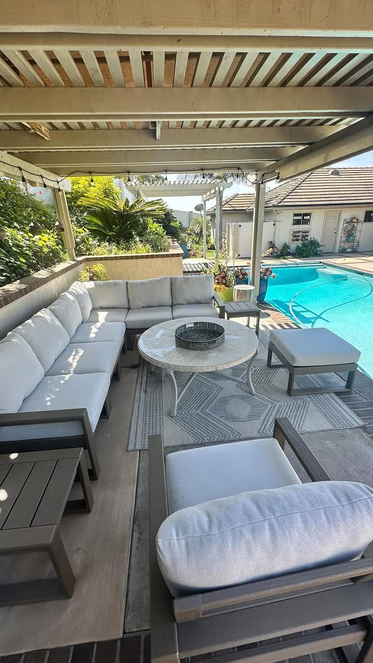 Outdoor Modular Seating: 20 Sectionals and Sofa Sets 9 Grey modular outdoor sectional sofa with light cushions on a patio by a pool.