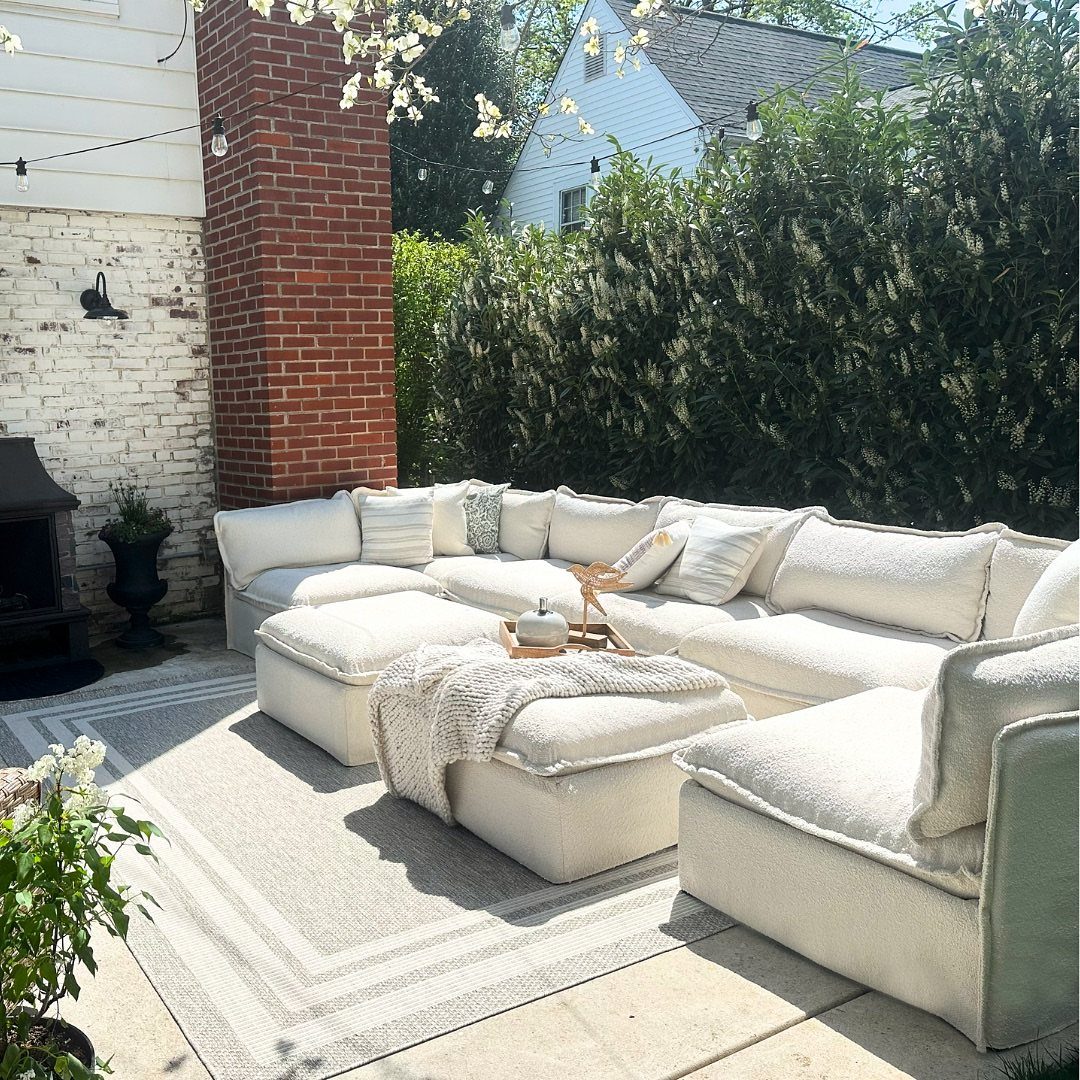 Outdoor Modular Seating: 20 Sectionals and Sofa Sets 3 White modular outdoor sectional sofa with plush cushions on a grey patio rug.