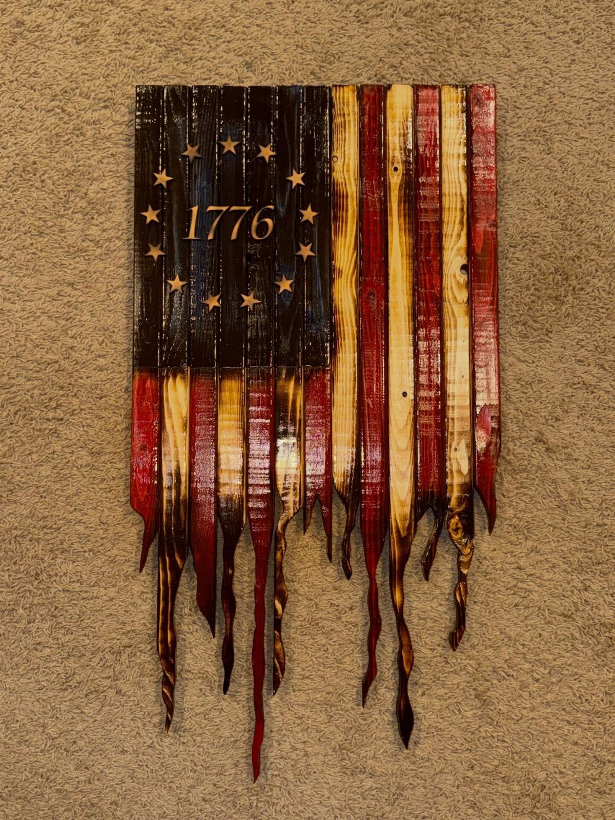 Rustic American flag made from pallet wood with 1776 and jagged bottom edges.