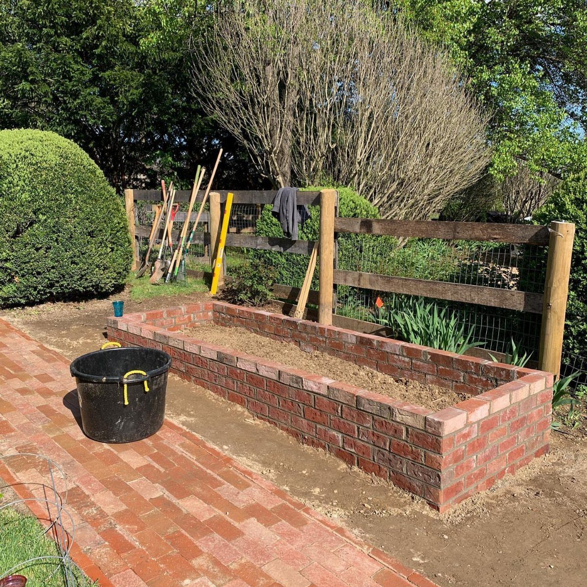 Raised Beds Garden: 25 Ideas from Wood, Metal, and Stone 1 Rectangular red brick raised garden bed with a brick cap and nearby path.