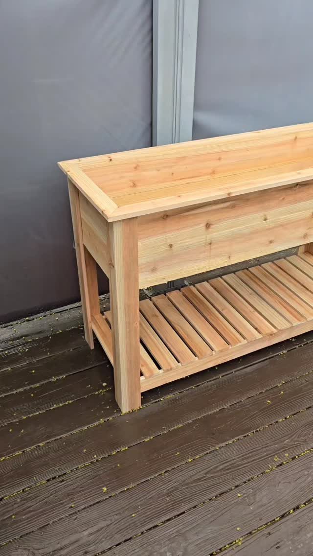 Raised Beds Garden: 25 Ideas from Wood, Metal, and Stone 8 Cedar raised garden bed with legs and a lower slatted storage shelf on a deck.