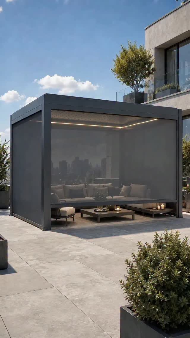 Modern grey freestanding cabana with lounge seating on a concrete rooftop patio