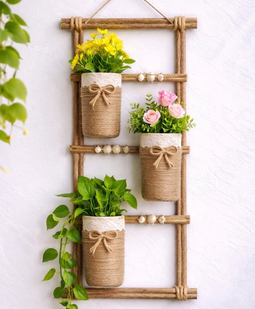 18 Unique Pots for Plants, From Resin Corgis to Copper Flowers 6 Three twine-wrapped plant pots attached to a hanging wooden ladder frame.